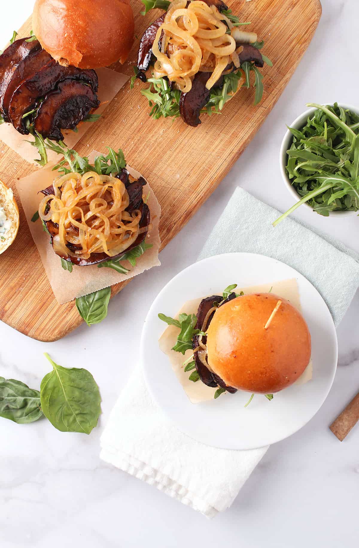 Open-faced portobello sliders on wooden platter