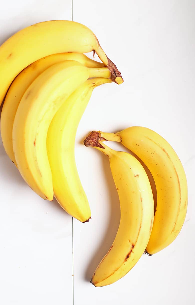 Two bunches of bananas on white background