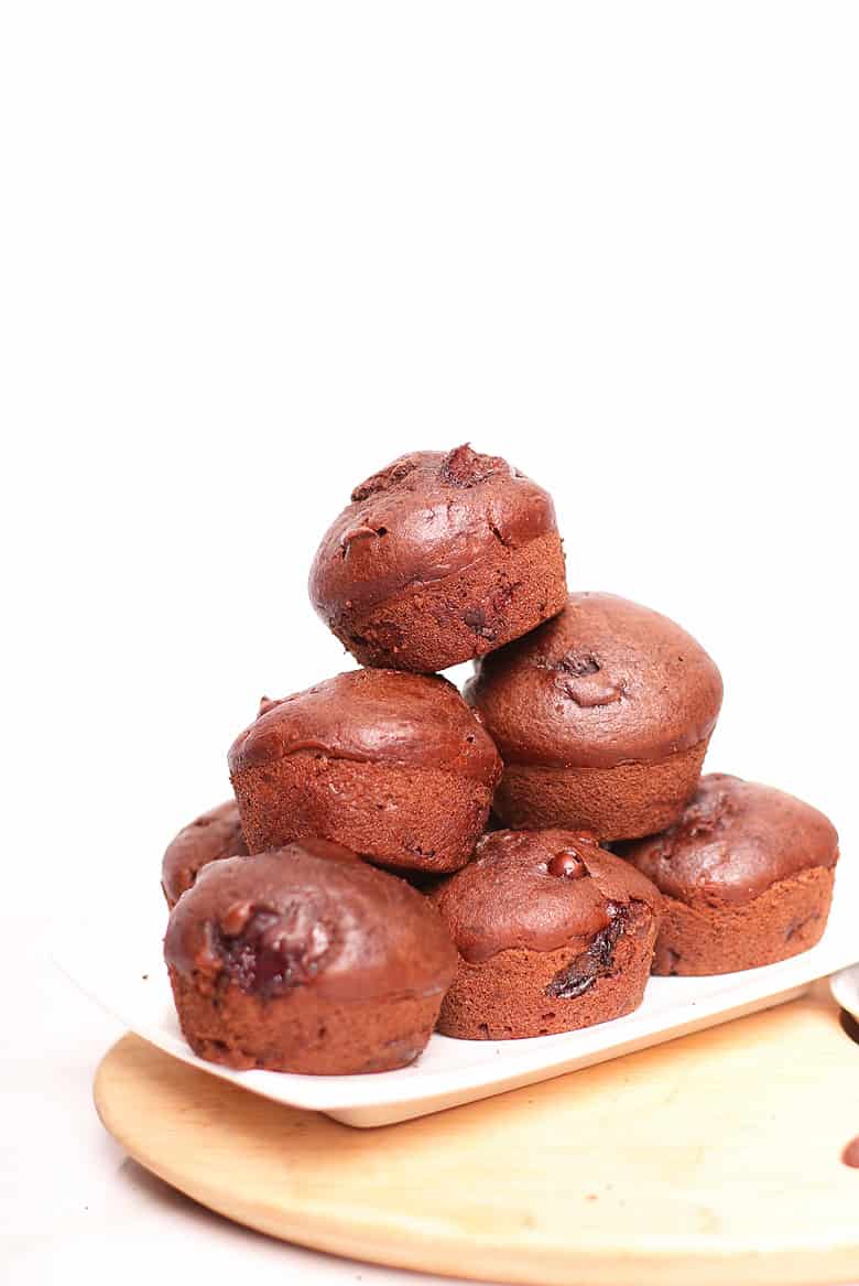 Pile of finished muffins on a white platter