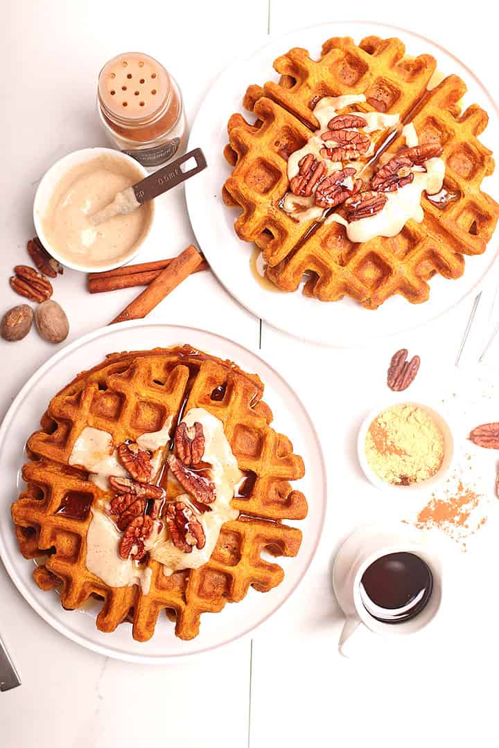 Vegan pumpkin waffles on two white plates