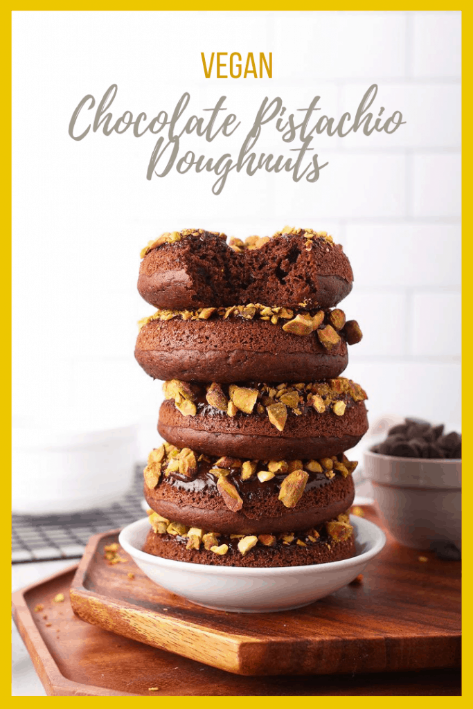 Bite into these amazing baked vegan chocolate donuts. They are dipped in chocolate ganache and topped with crushed pistachios for the perfect sweet and salty pastry.