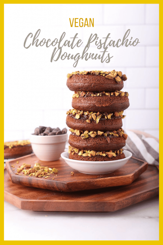 Bite into these amazing baked vegan chocolate donuts. They are dipped in chocolate ganache and topped with crushed pistachios for the perfect sweet and salty pastry.