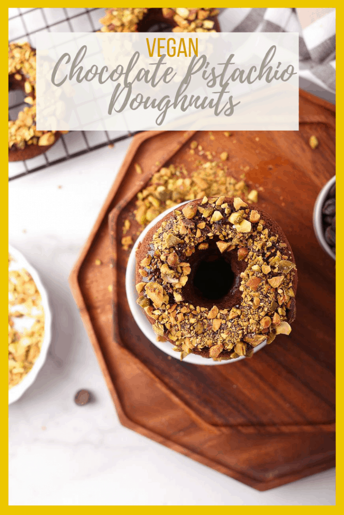 Bite into these amazing baked vegan chocolate donuts. They are dipped in chocolate ganache and topped with crushed pistachios for the perfect sweet and salty pastry.