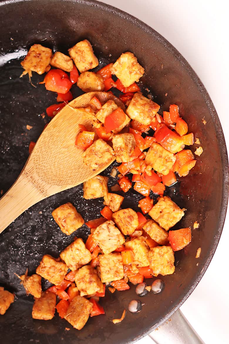 Sautéed tempeh and peppers in a skillet