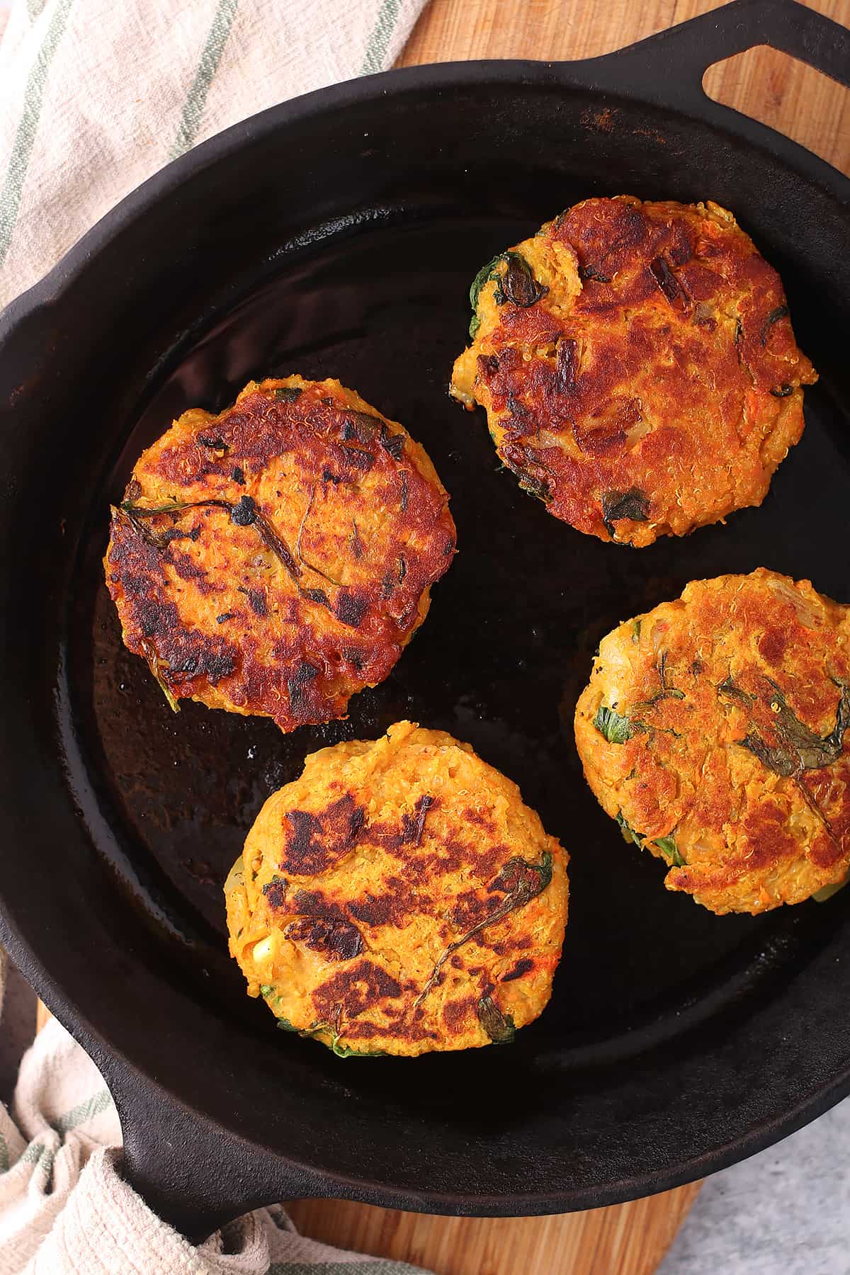 Cooked sweet potato burgers in a cast iron skillet