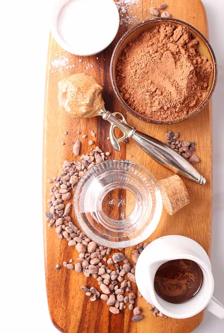 cacao powder, almond butter, and maple syrup on cutting board