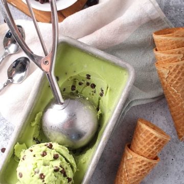 Ice cream in a loaf pan with a scoop.