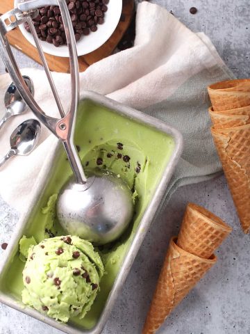 Ice cream in a loaf pan with a scoop.