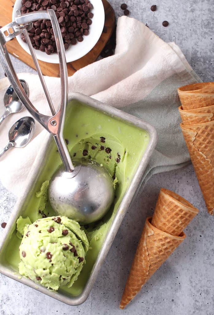 Ice cream in a loaf pan with a scoop.