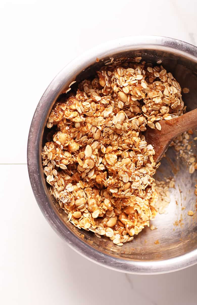 Peanut butter and oats mixed together in a metal bowl