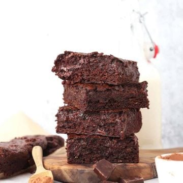 Stack of zucchini brownies next to milk