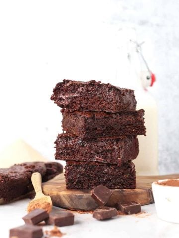 Stack of zucchini brownies next to milk