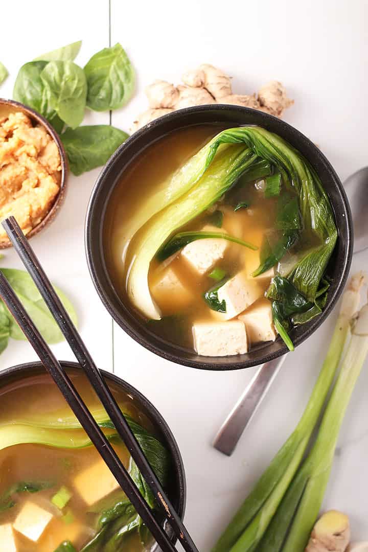 Two bowls of vegetable soup with tofu