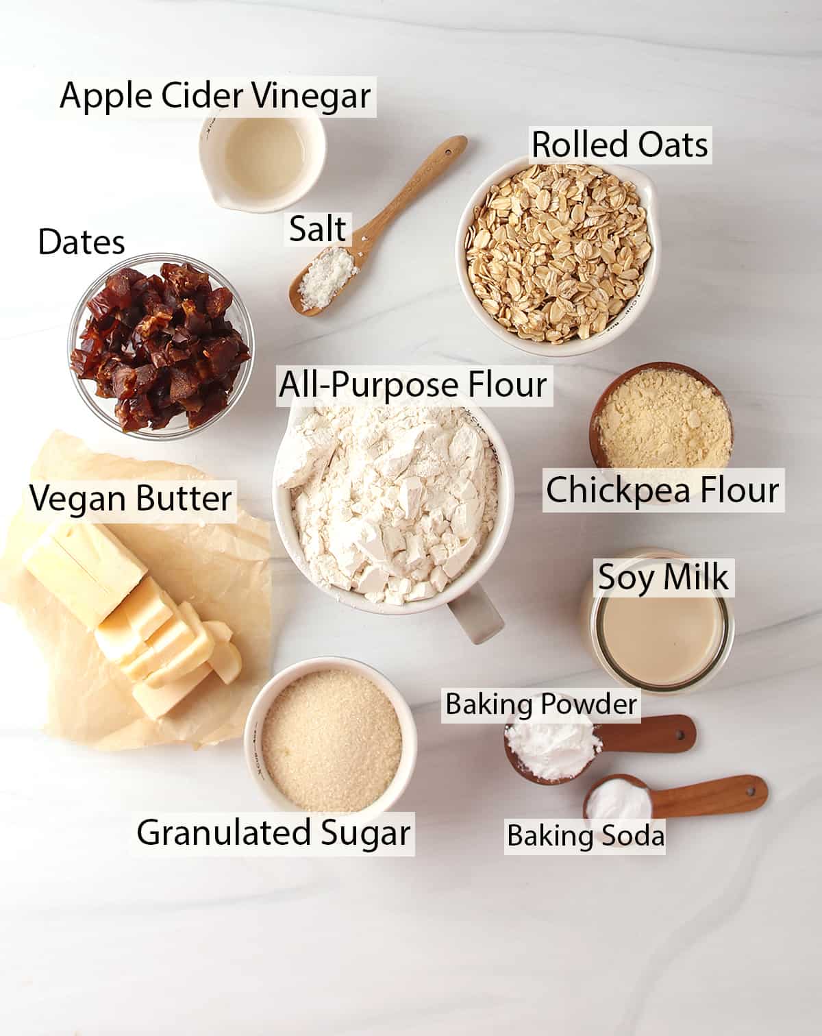 Ingredients for date scones measured out and placed on a marble countertop. 