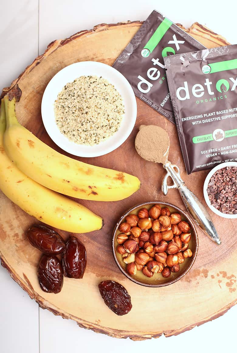 Hazelnuts, hemp, chocolate, and bananas on wooden board