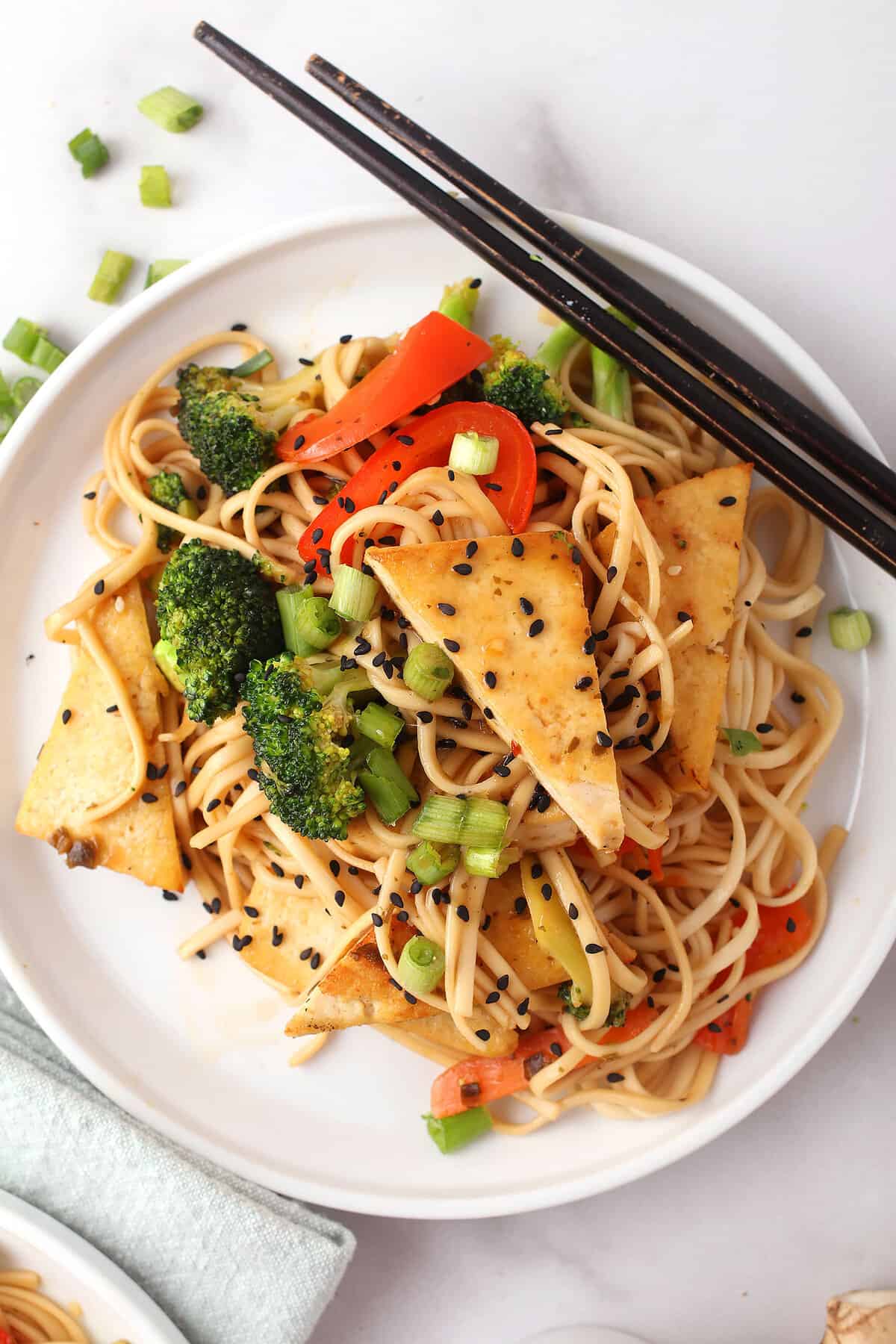 Udon Noodle Stir Fry on white plate with chopsticks