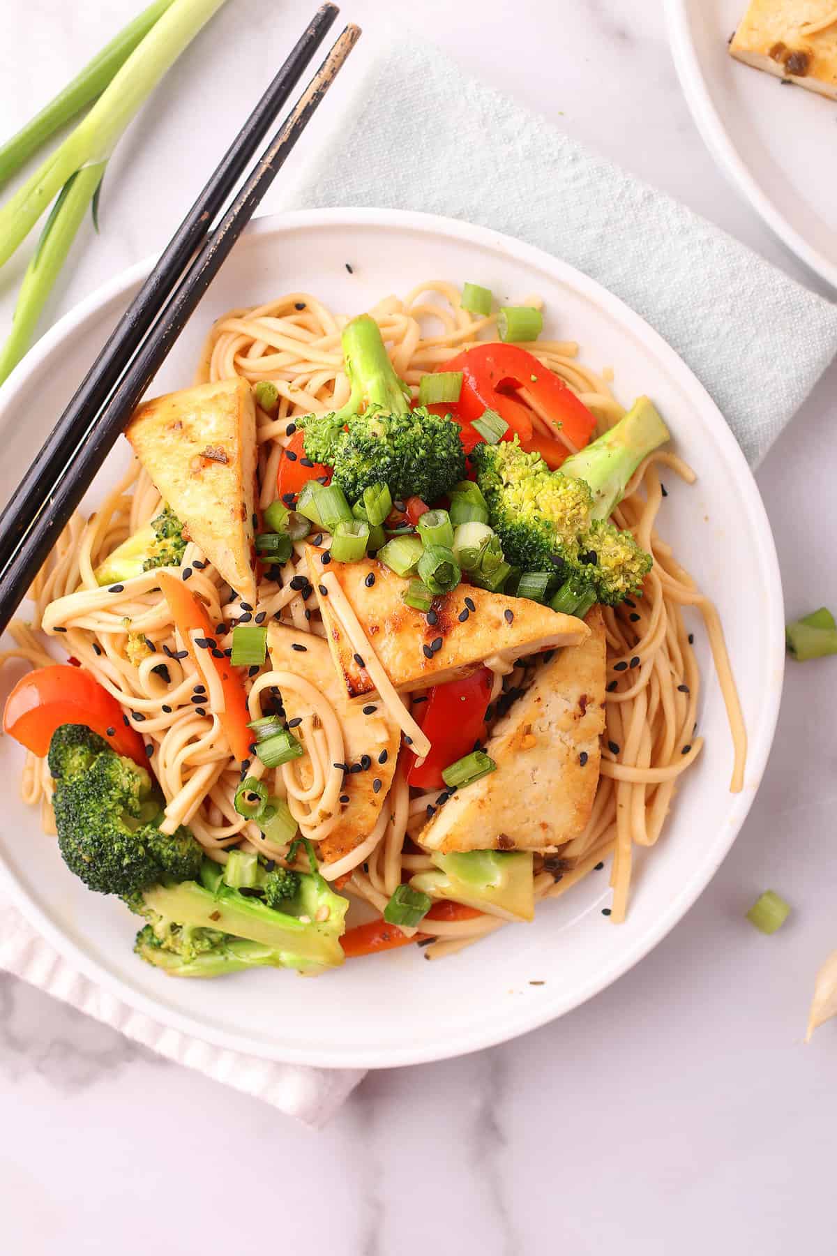 Udon Noodle Stir Fry on white plate with chopsticks