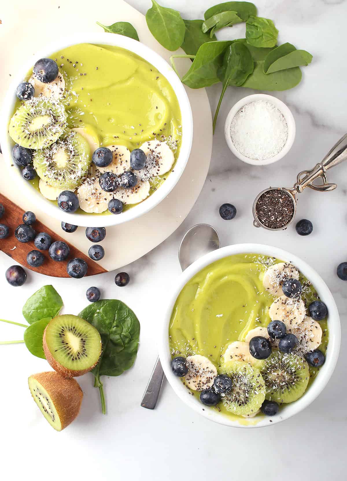 Two smoothie bowls on a white background with berries and fruit