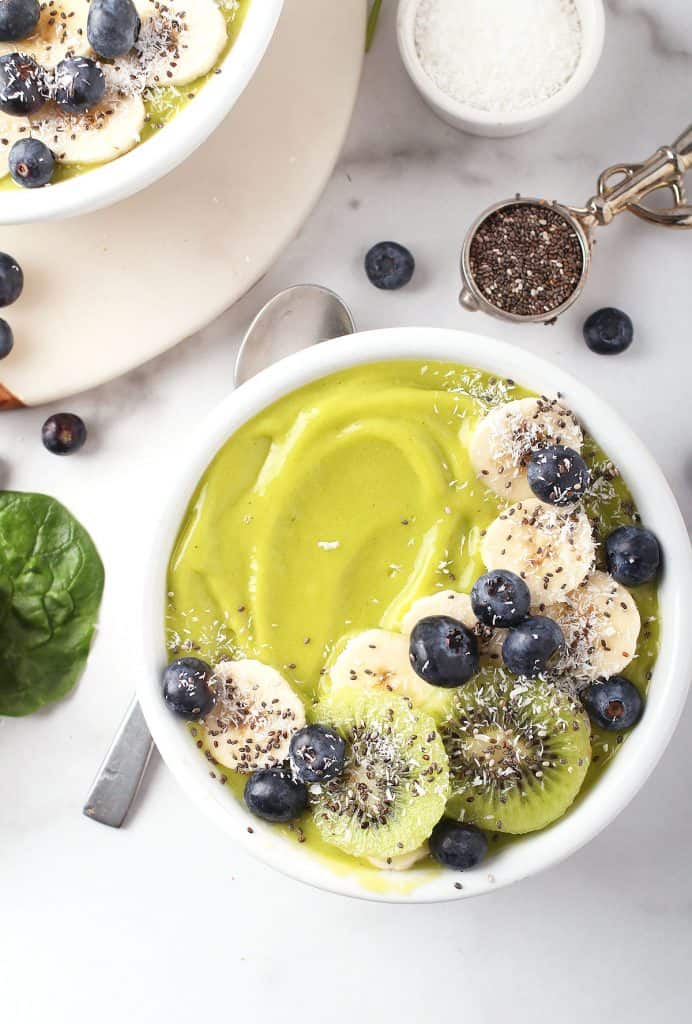 Close up of green smoothie bowl with bananas and blueberries