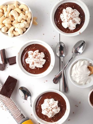 Three vegan pots de creme with whipped cream