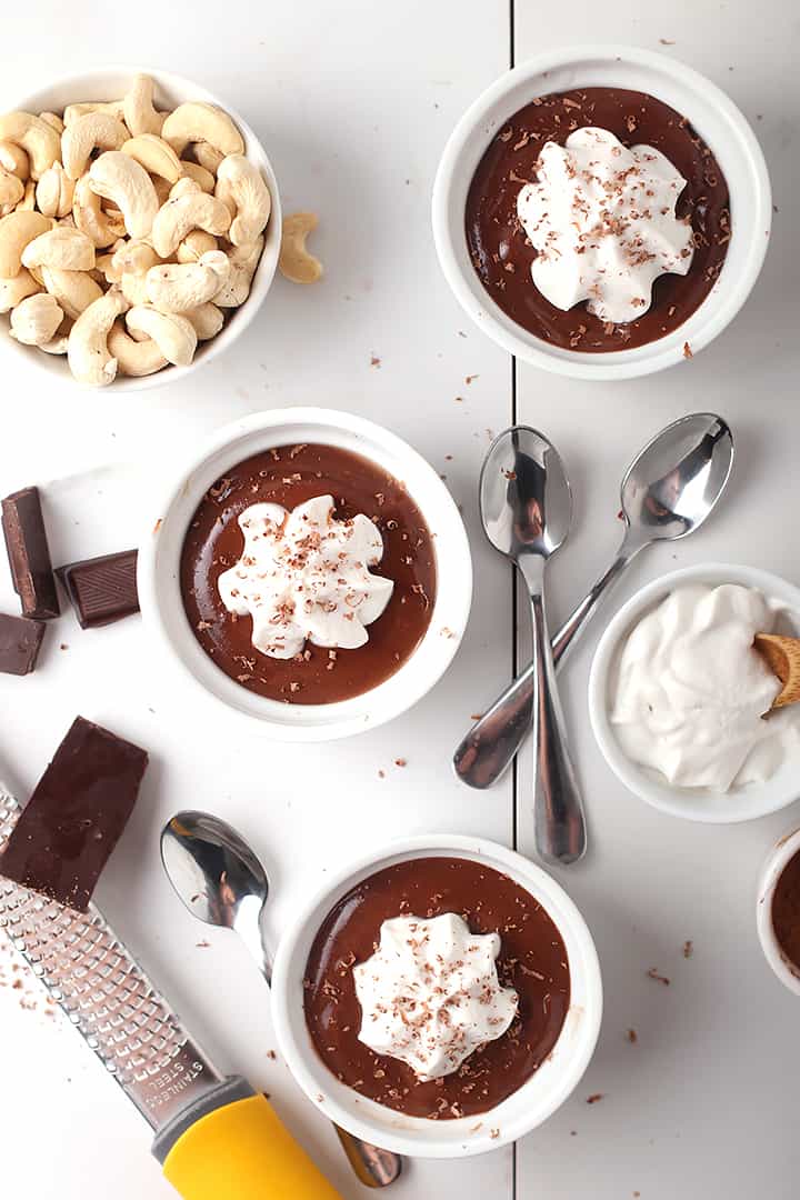 Three vegan pots de creme with whipped cream