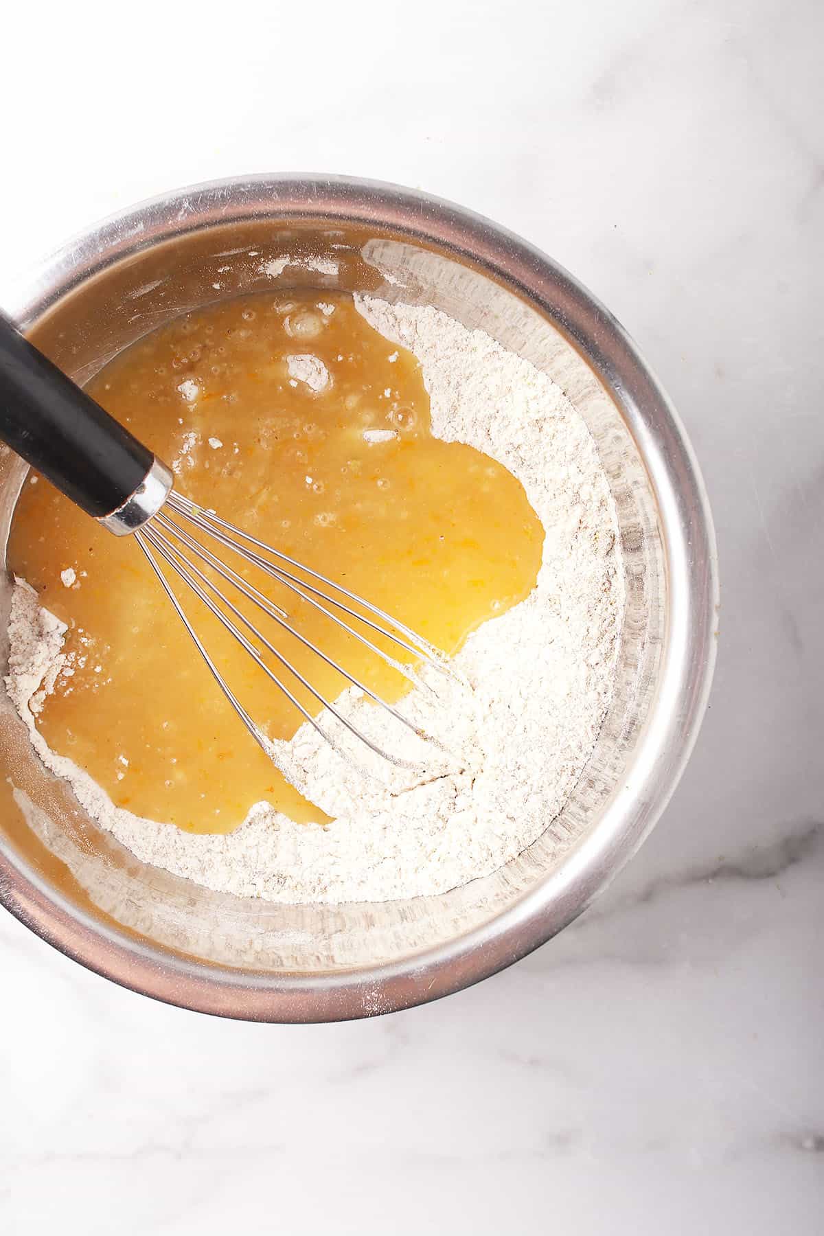 Wet and dry ingredients in a metal bowl