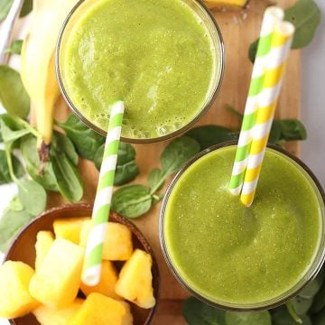 Two Tropical Green Smoothie on a platter