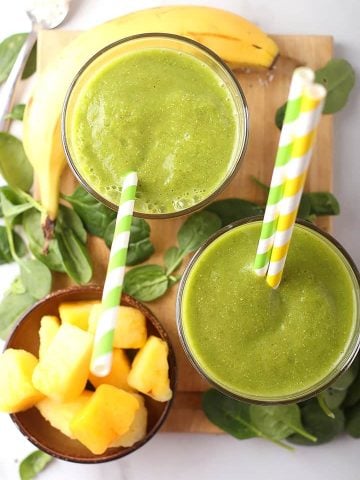 Two Tropical Green Smoothie on a platter