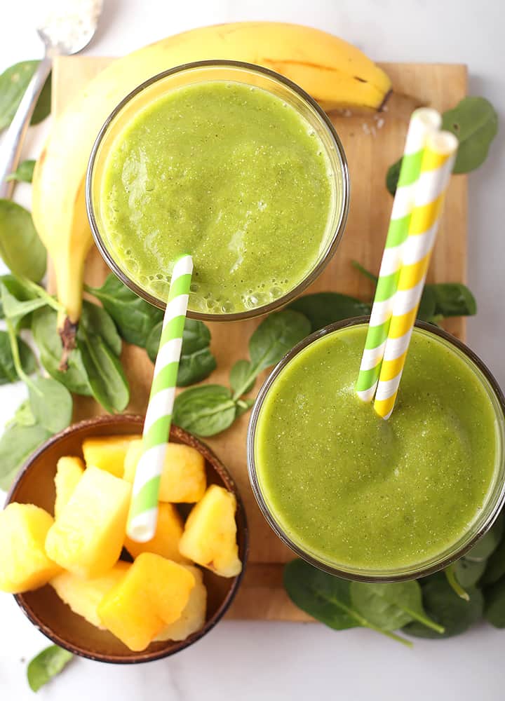 Two Tropical Green Smoothie on a platter