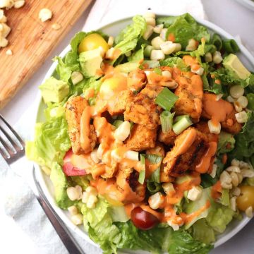 Finished salad on a white plate with a fork