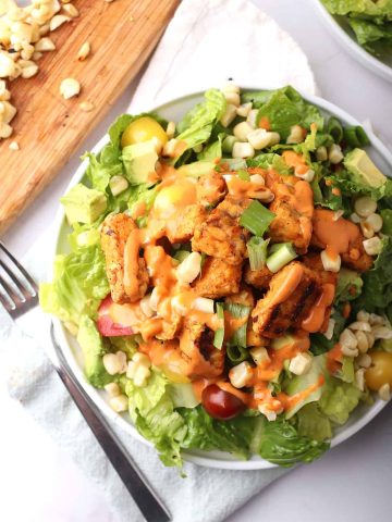 Finished salad on a white plate with a fork