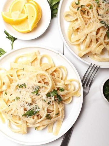 Plate of fettuccine Alfredo with vegan parmesan