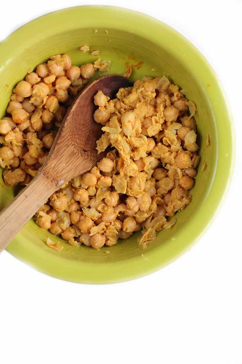 Mashed chickpeas in a green bowl