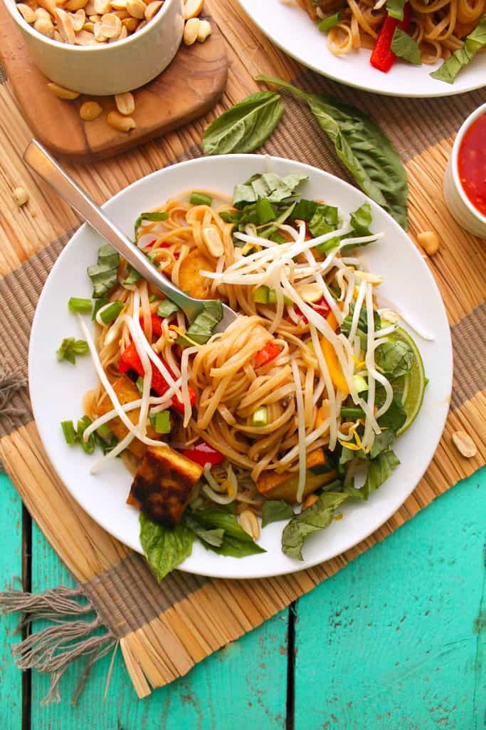 Pad Thai on a white plate with a fork