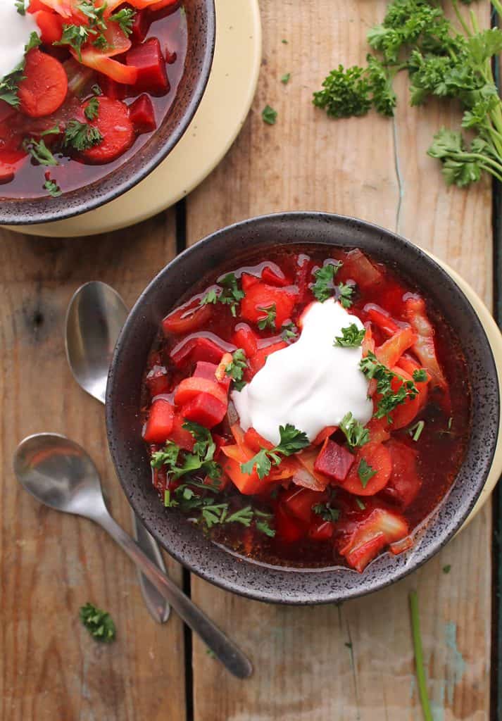 A bowl of vegan borscht topped with sour cream