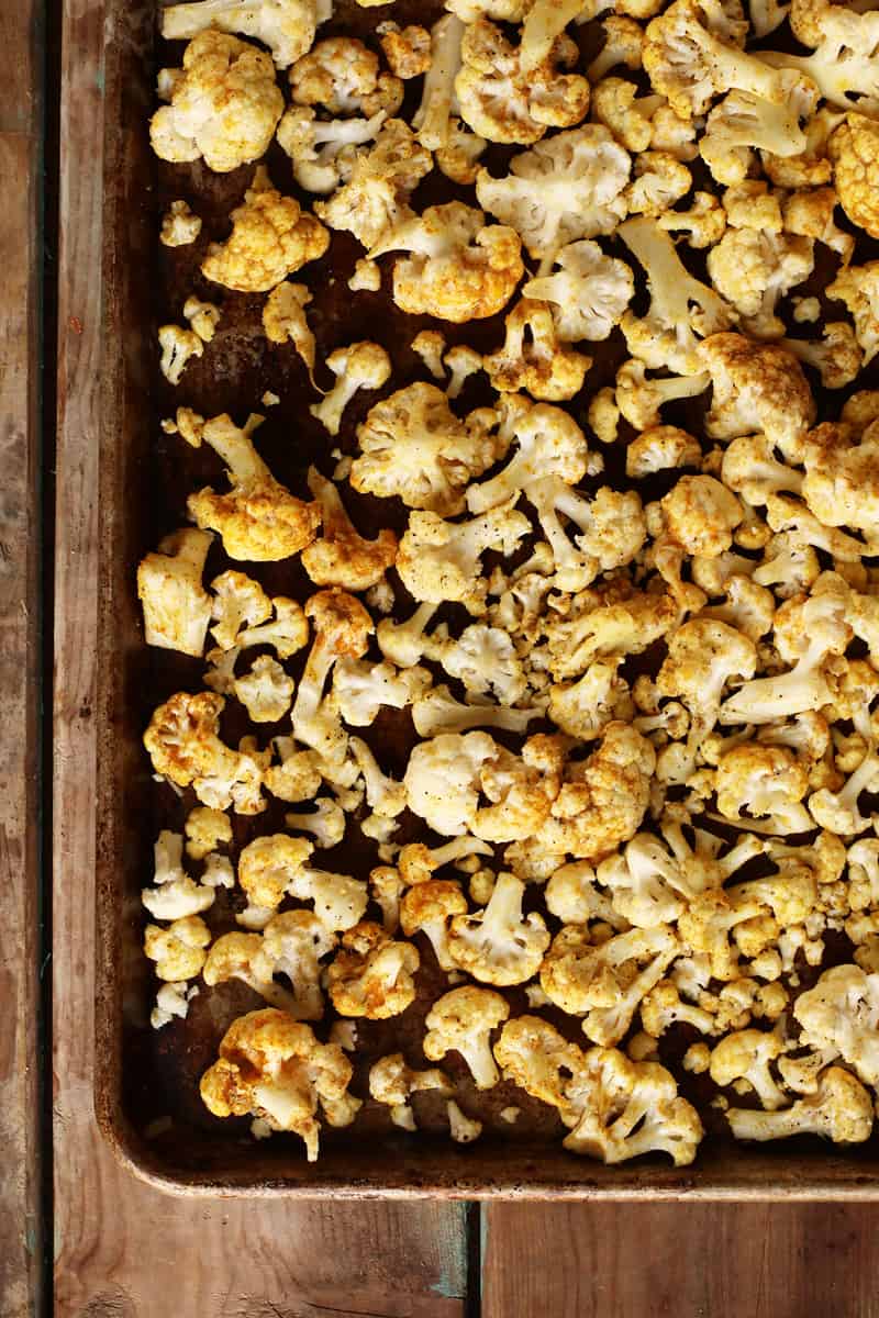 Roasted cauliflower florets on baking sheet