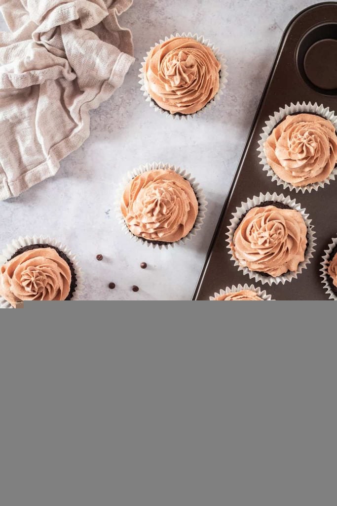 Overhead shot of finished cupcakes with chocolate buttercream 