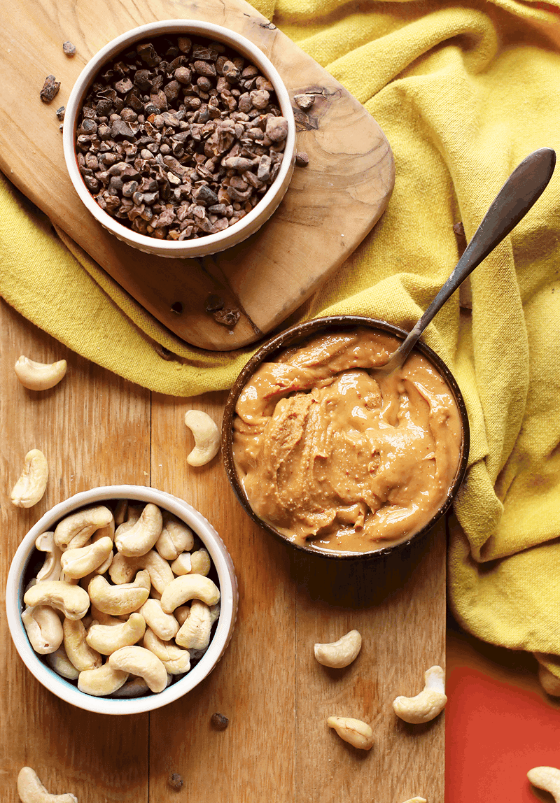 Peanut butter, cacao, and cashews in bowls
