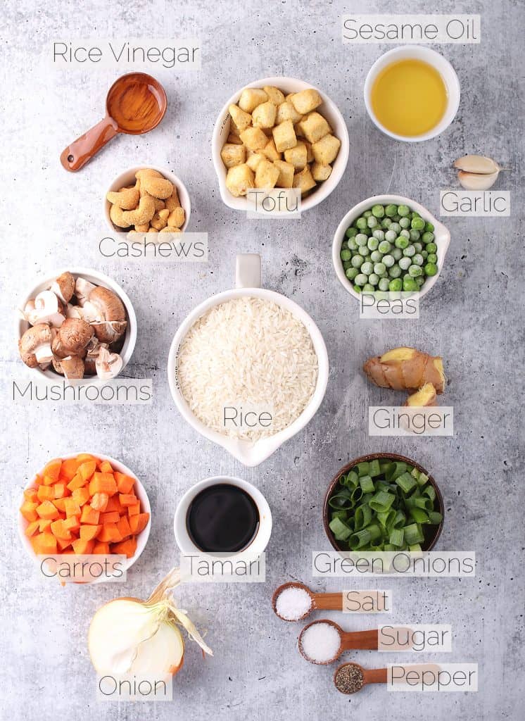 Ingredients for vegan fried rice on a cement countertop