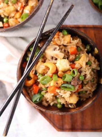 Finished dish in a wooden bowl with chopsticks