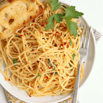 Finished dish on a white plate with toasted bread