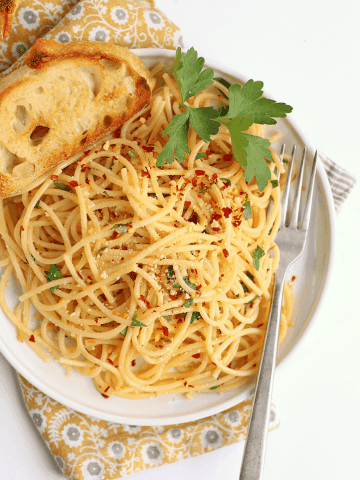 Finished dish on a white plate with toasted bread