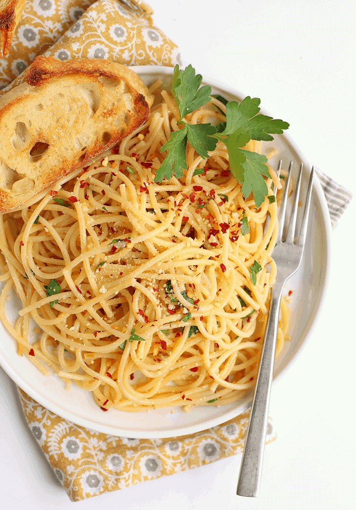 Finished dish on a white plate with toasted bread