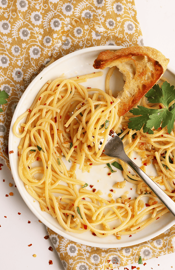 Half eaten plate of pasta with a fork in the middle