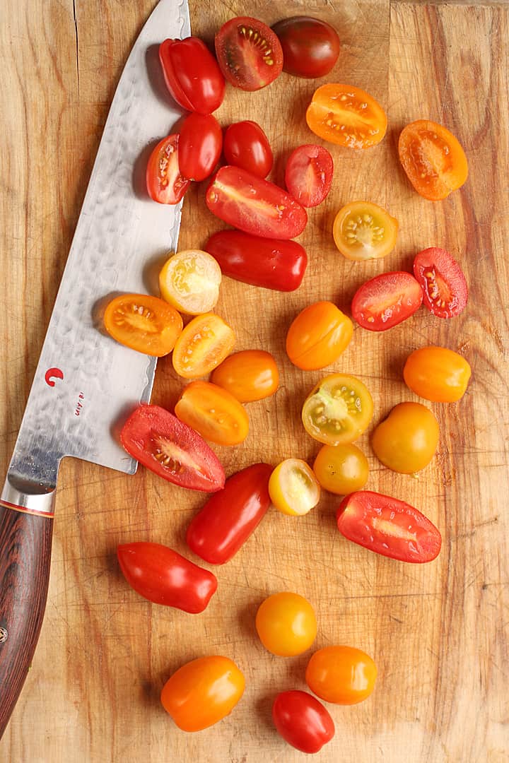 Chopped cherry tomatoes on a cutting board