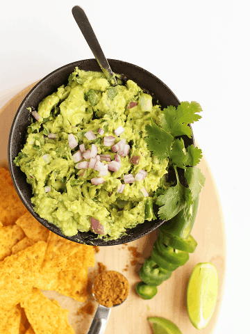 Homemade Guacamole in a small black bowl