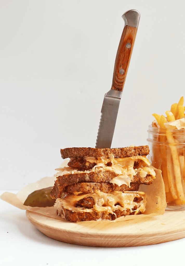 Vegan Tempeh Reuben on a wooden platter