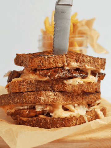 Finished sandwich on a wooden board with a steak knife