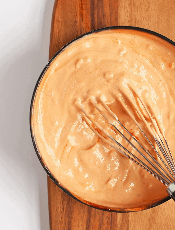 Vegan Dressing in a black bowl with a whisk