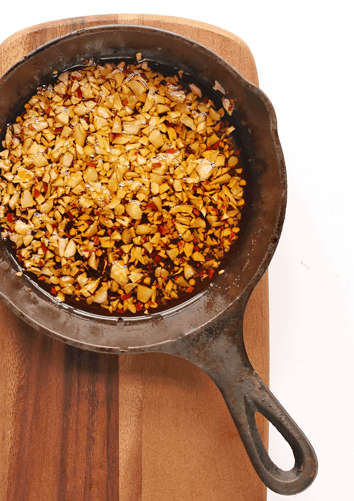Roasted garlic and red pepper flakes in a cast iron skillet